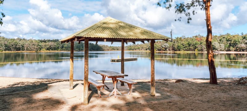 A shaded picnic table beside Lake Leschenaultia.