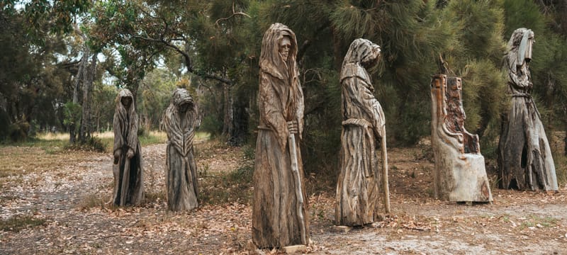 Carved Grim Reaper figures along the Chainsaw Sculpture Drive in Albany, Western Australia